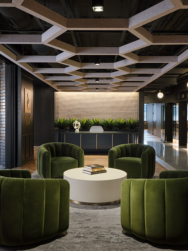 Hexagonal acoustic ceiling baffles in a moody club lounge