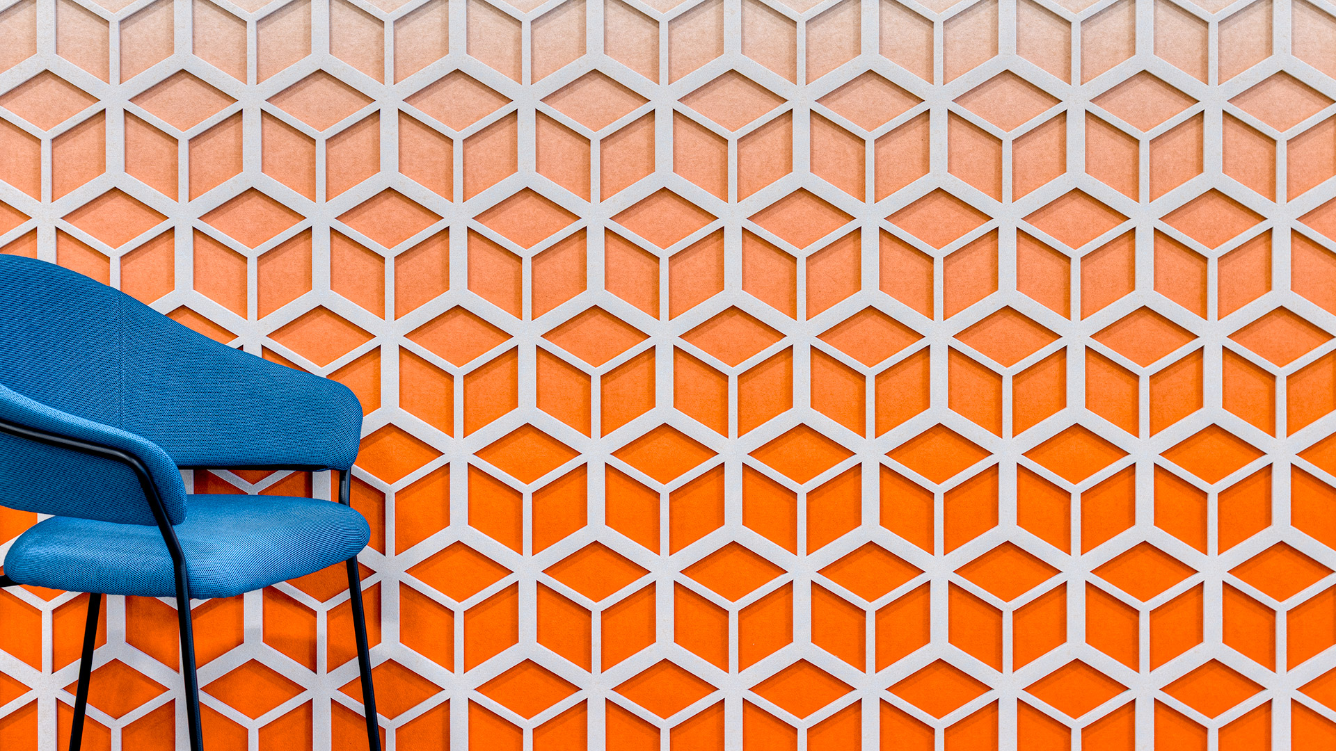 Bold orange gradient cube acoustic panels as feature wall