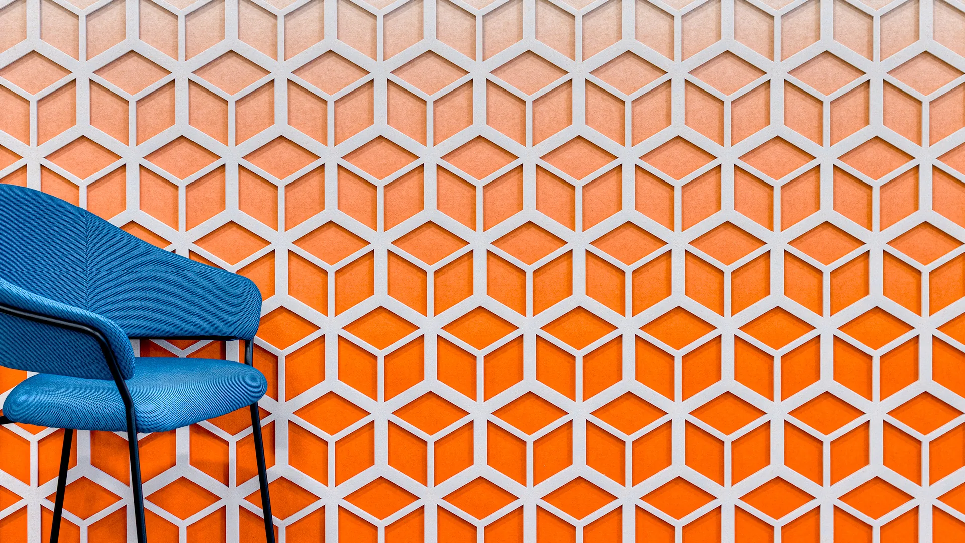 Bold orange gradient cube acoustic panels as feature wall