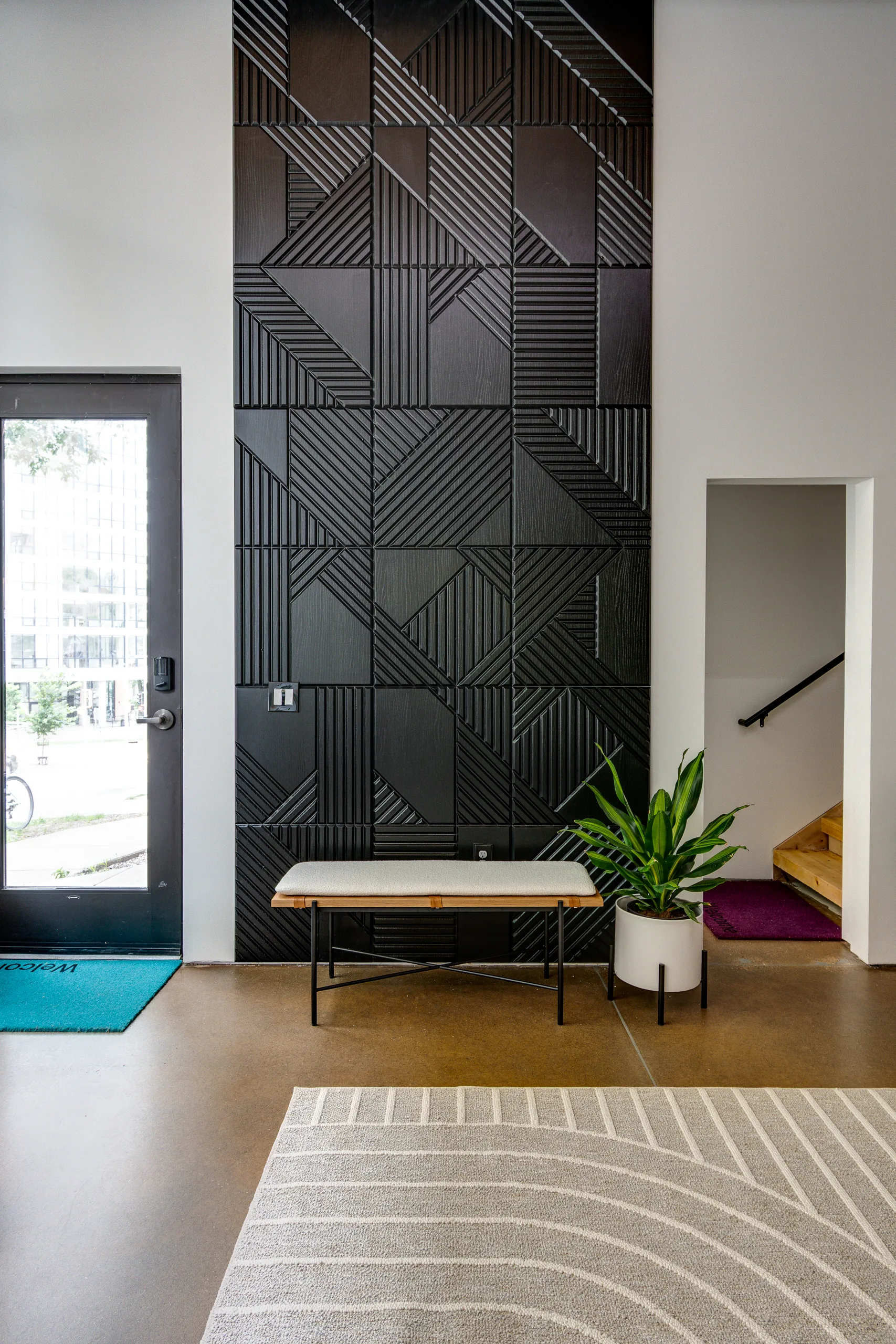 Dark angular geometric cladding as entry feature wall