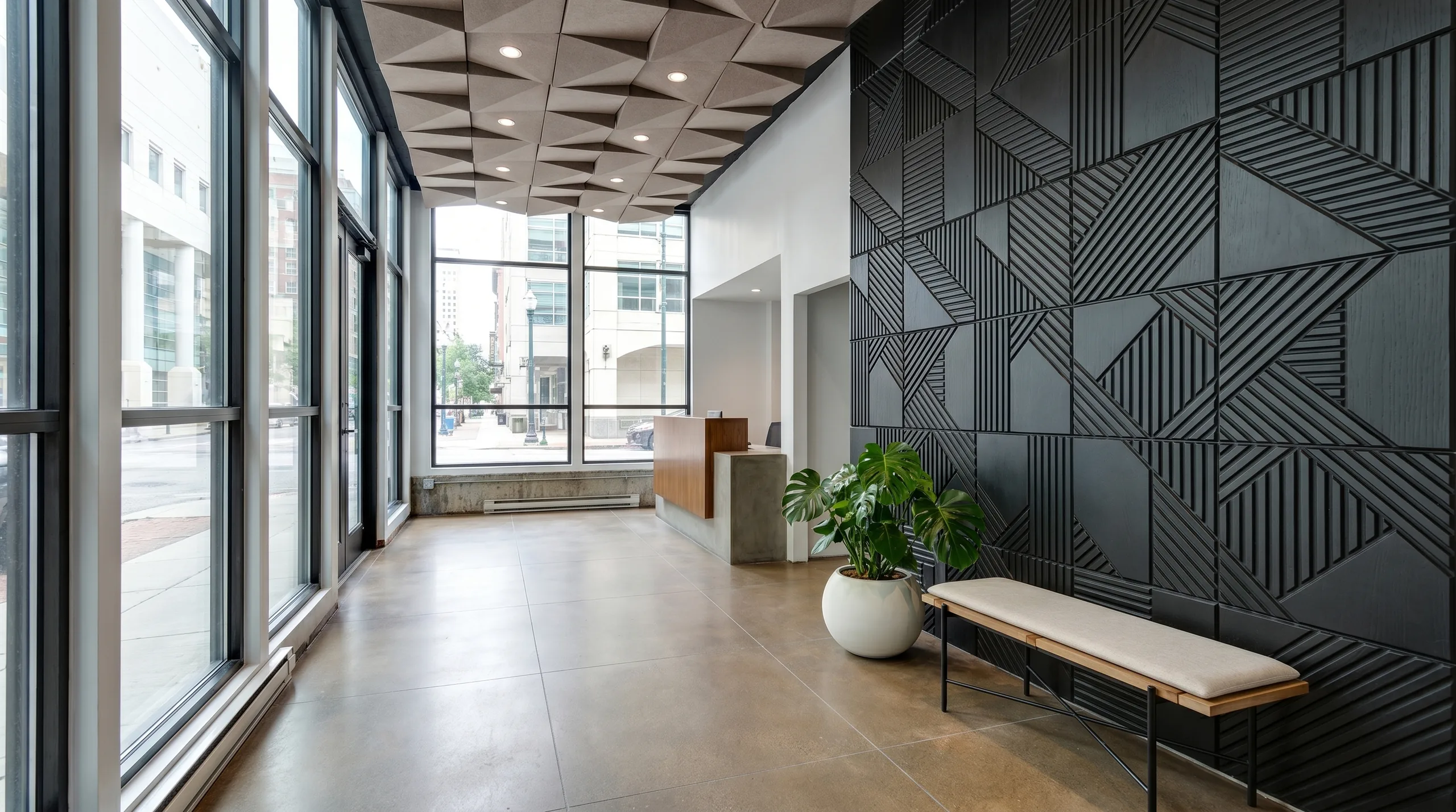 Passi dark geometric entry wall and 3D acoustic tiles in boutique hotel lobby