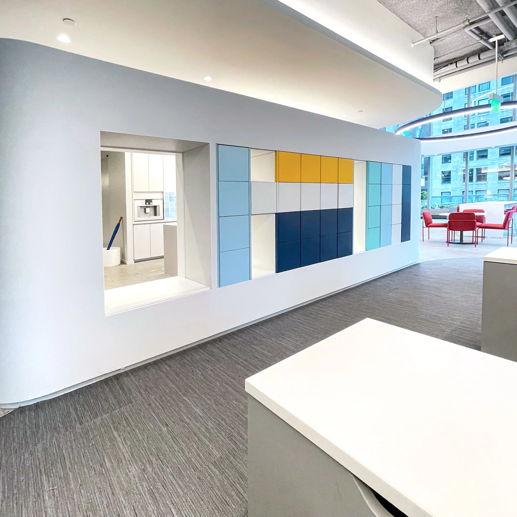 Installed custom locker wall composed like a palette, warm yellow and soft white played against layered blues