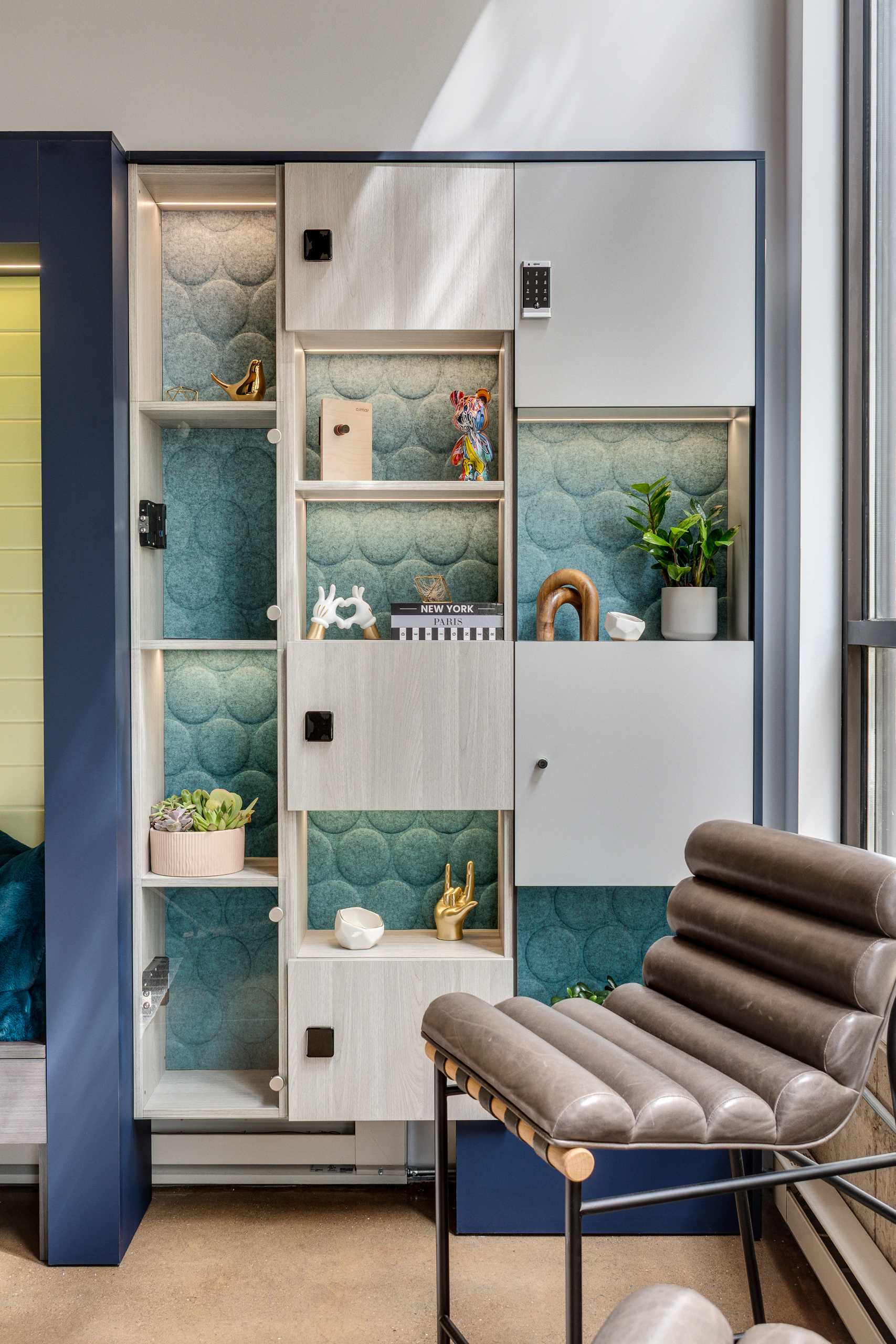 Open display-style lockers with teal acoustic back panels in a showroom setting