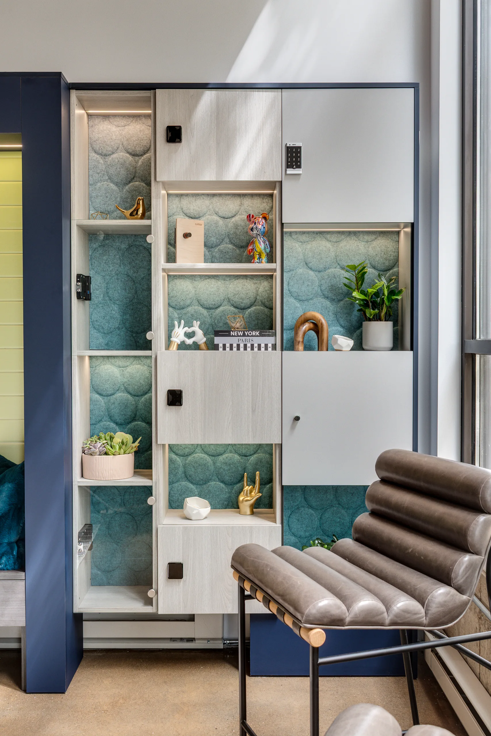 Open display-style lockers with teal acoustic back panels in a showroom setting