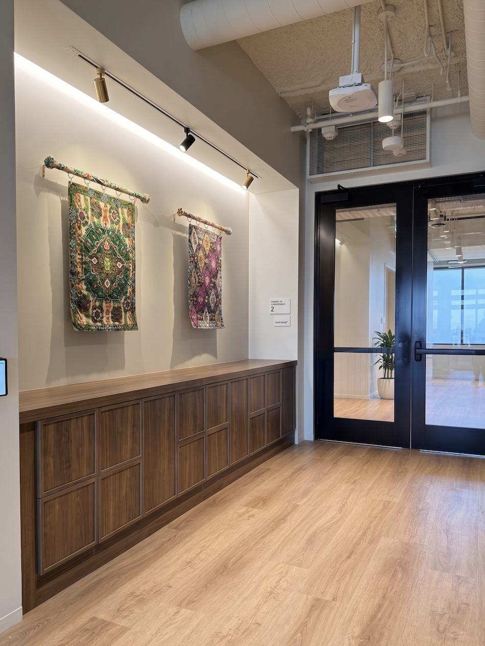 Low-profile walnut shaker locker run reading as millwork along a corridor