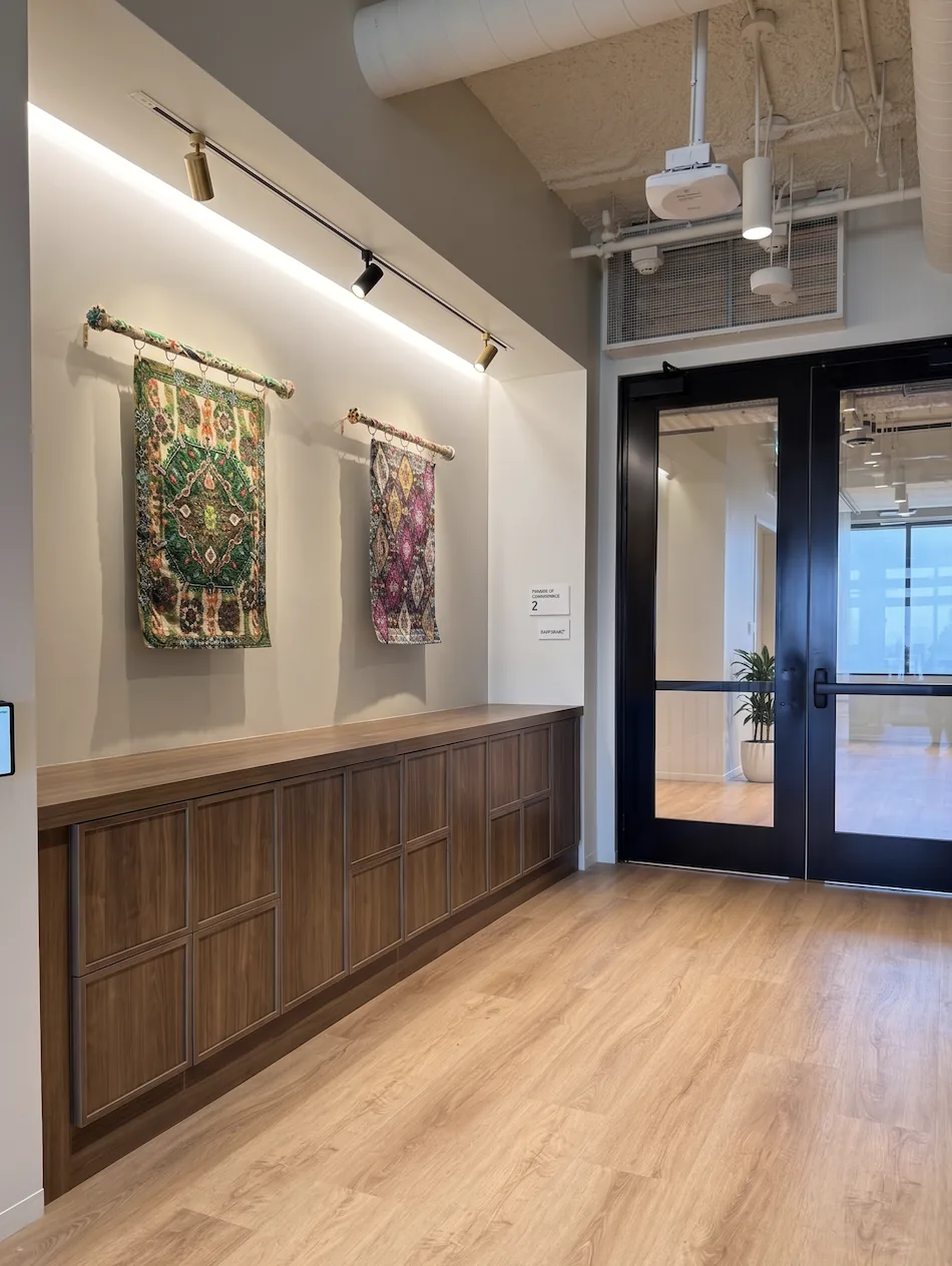 Low-profile walnut shaker locker run reading as millwork along a corridor