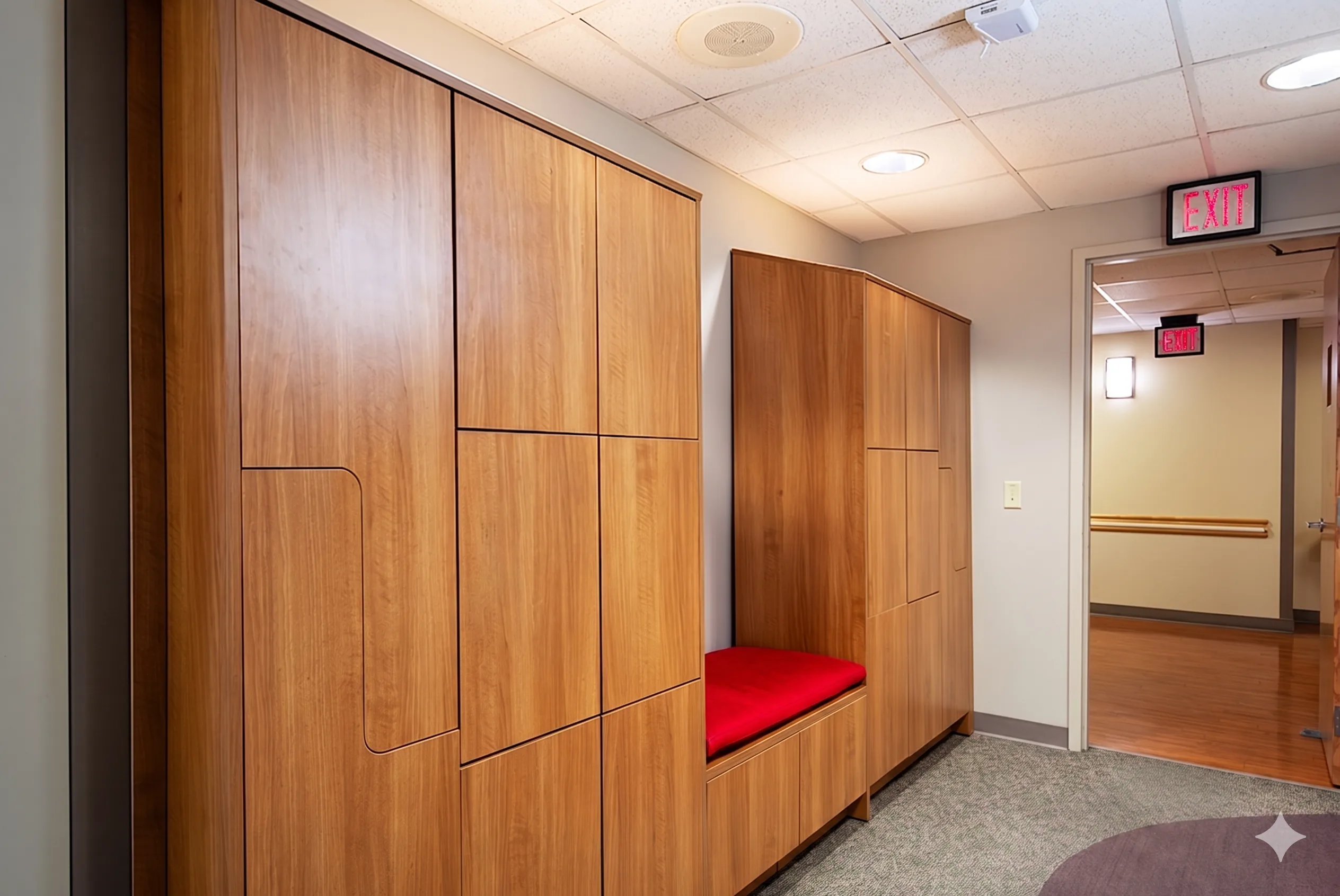Wood lockers with red padded seat cutout niche at a university