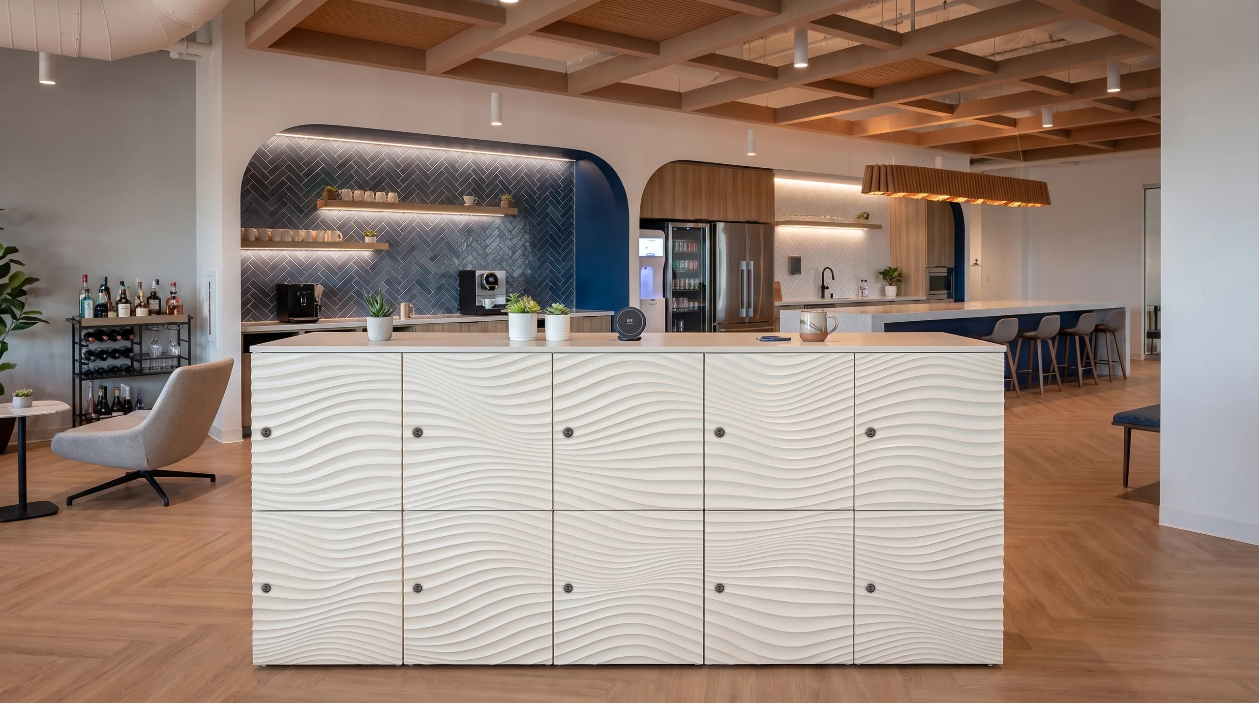 Wave-texture island in upscale interior with herringbone tile and coffered ceiling