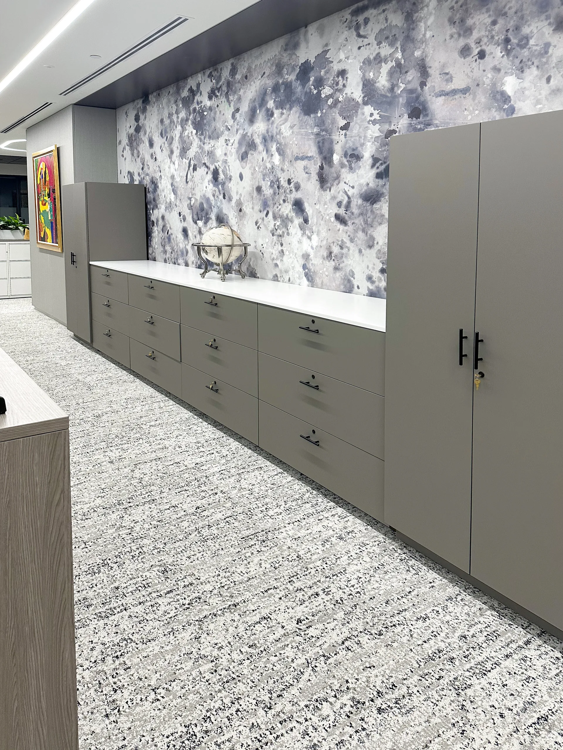 Casework storage wall with drawers and open shelving
