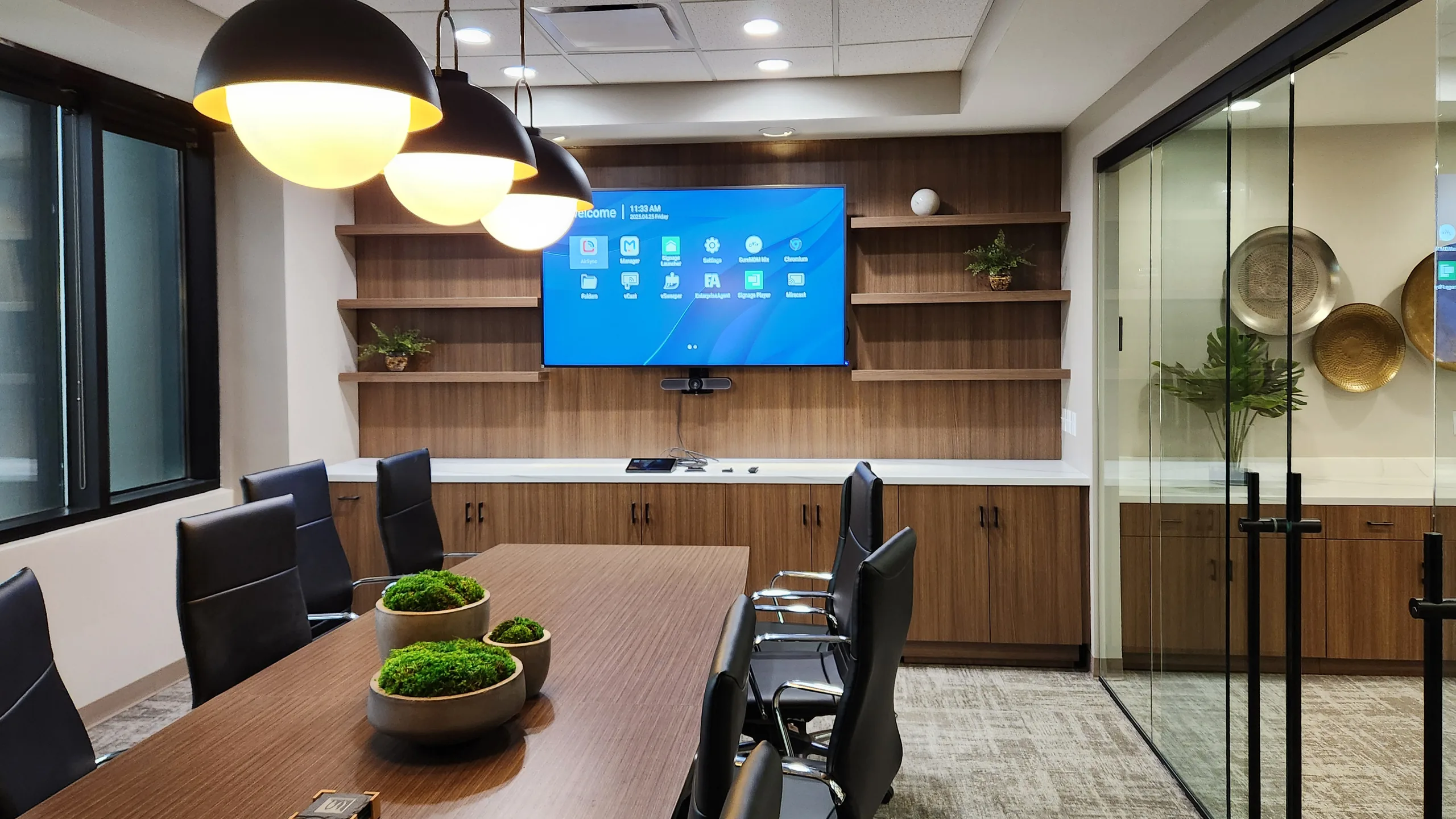 Walnut floating shelves and TV wall in conference room