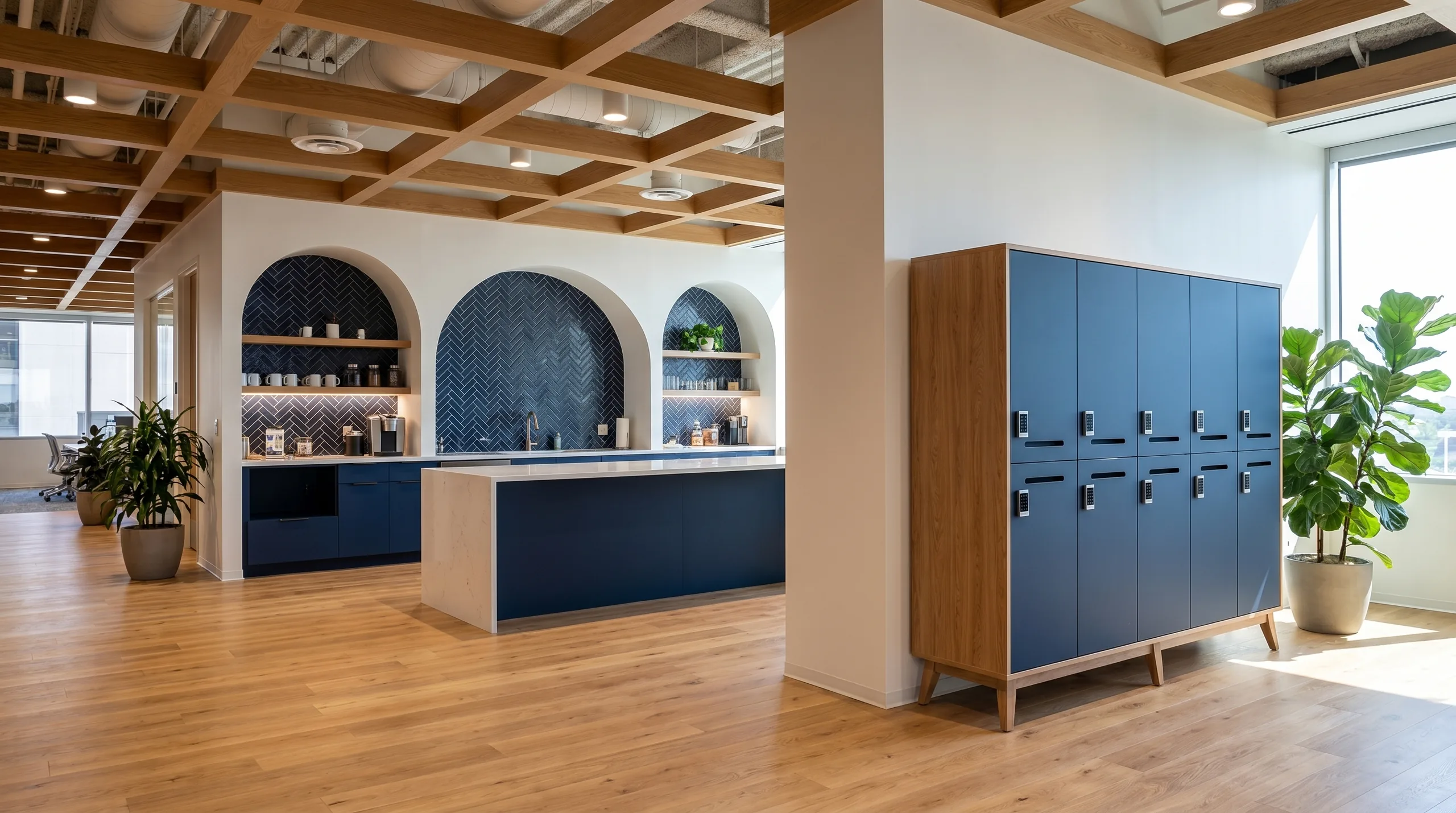 Open office bold pantry with arched casework niches and island in a tech office environment