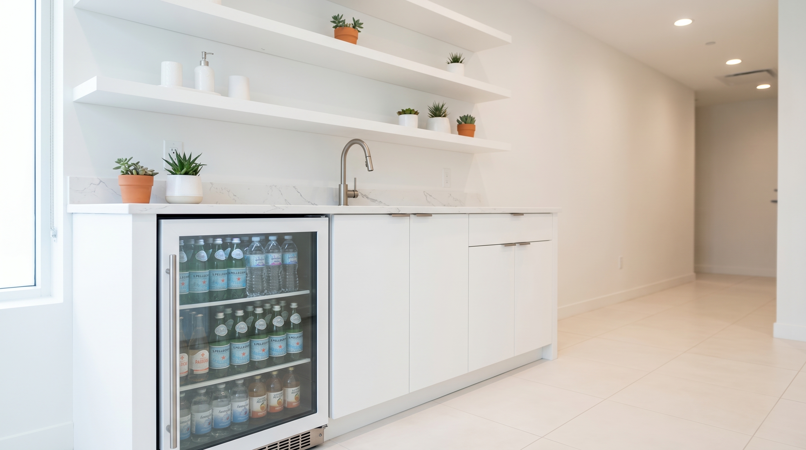 Wellness center hydration station with white casework and glass-door fridge