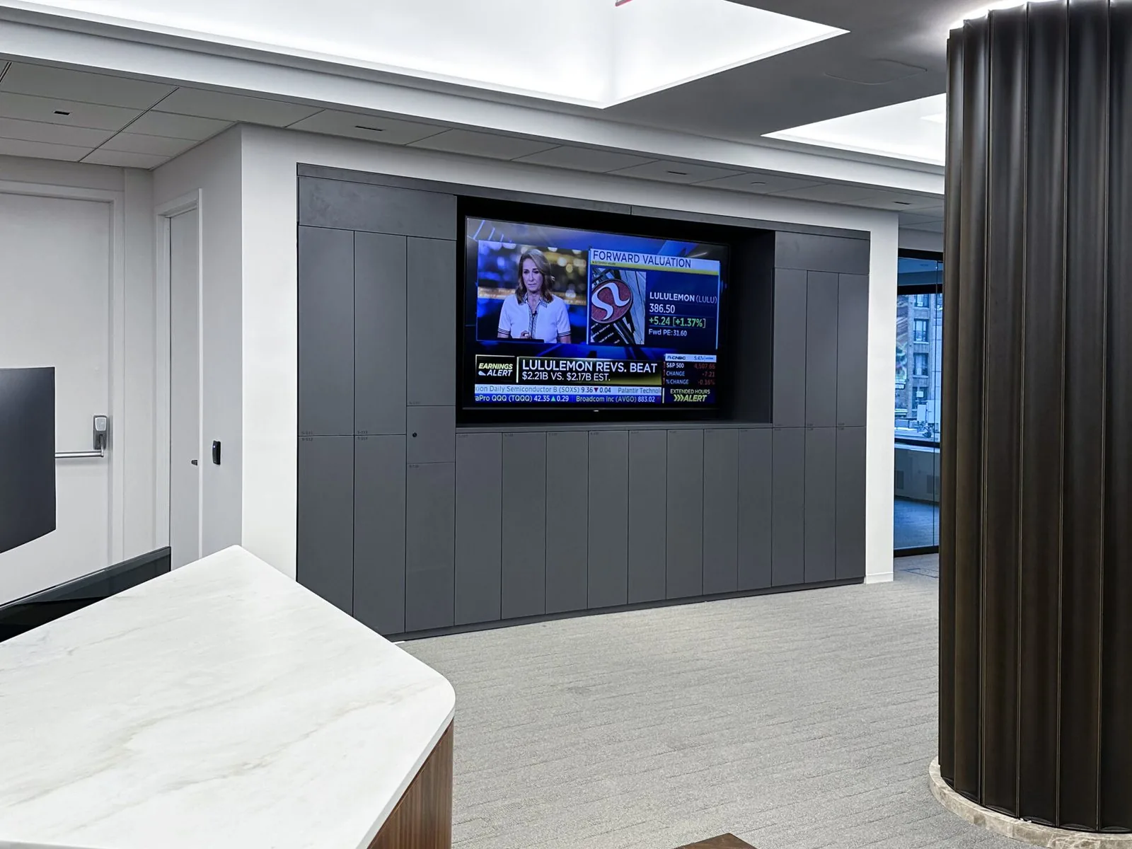 Charcoal storage wall with a recessed media display and stone counter return