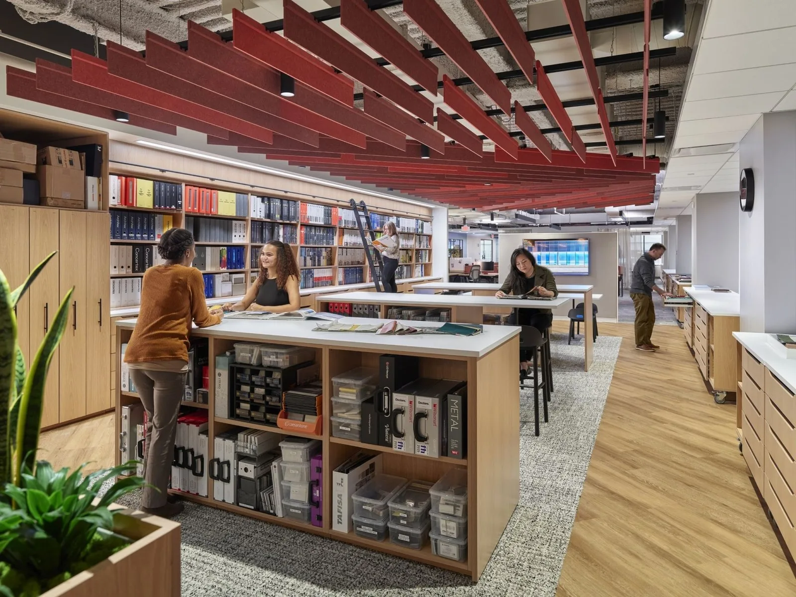 Oak resource islands with open shelving and worksurfaces in a materials library