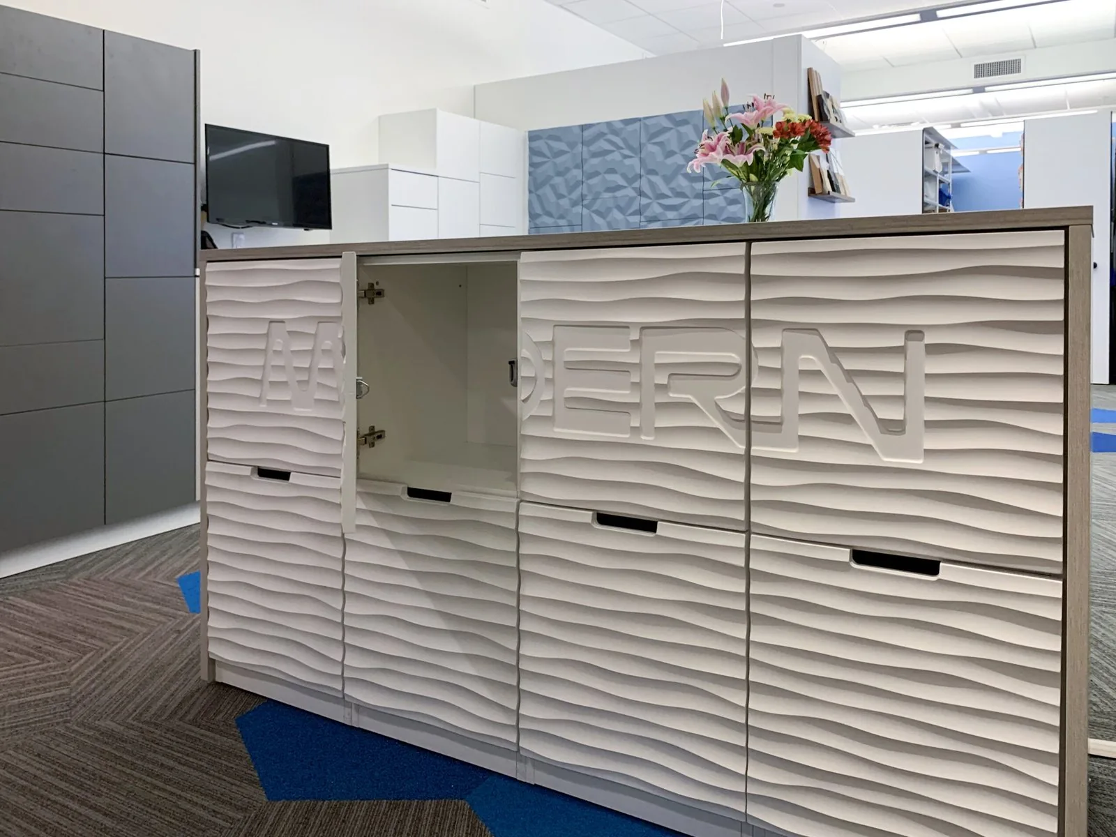 Wave-texture locker doors with routed lettering and inline pulls