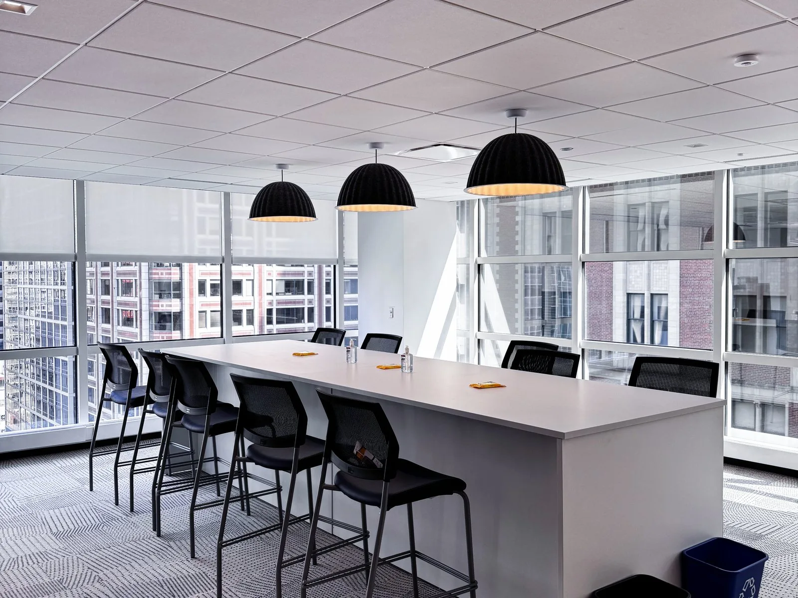 Counter-height island with barstools running along a full-height window line