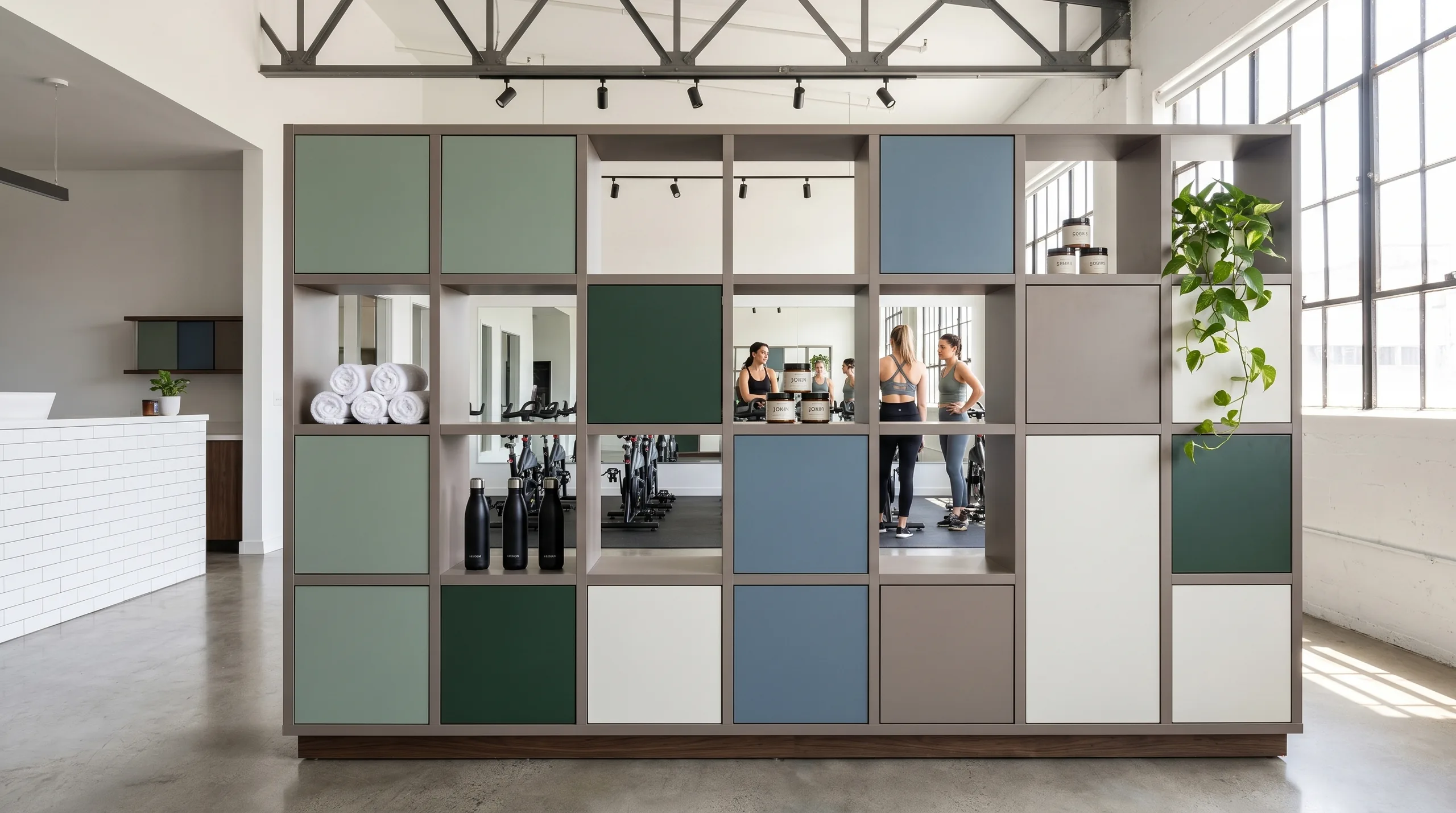 Zone Divider on boutique fitness training floor with open cubbies, closed storage, and studio sightlines behind